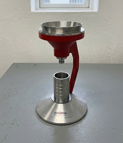 Apparent density testing equipment being used in a pharmaceutical lab to evaluate powder flowability.