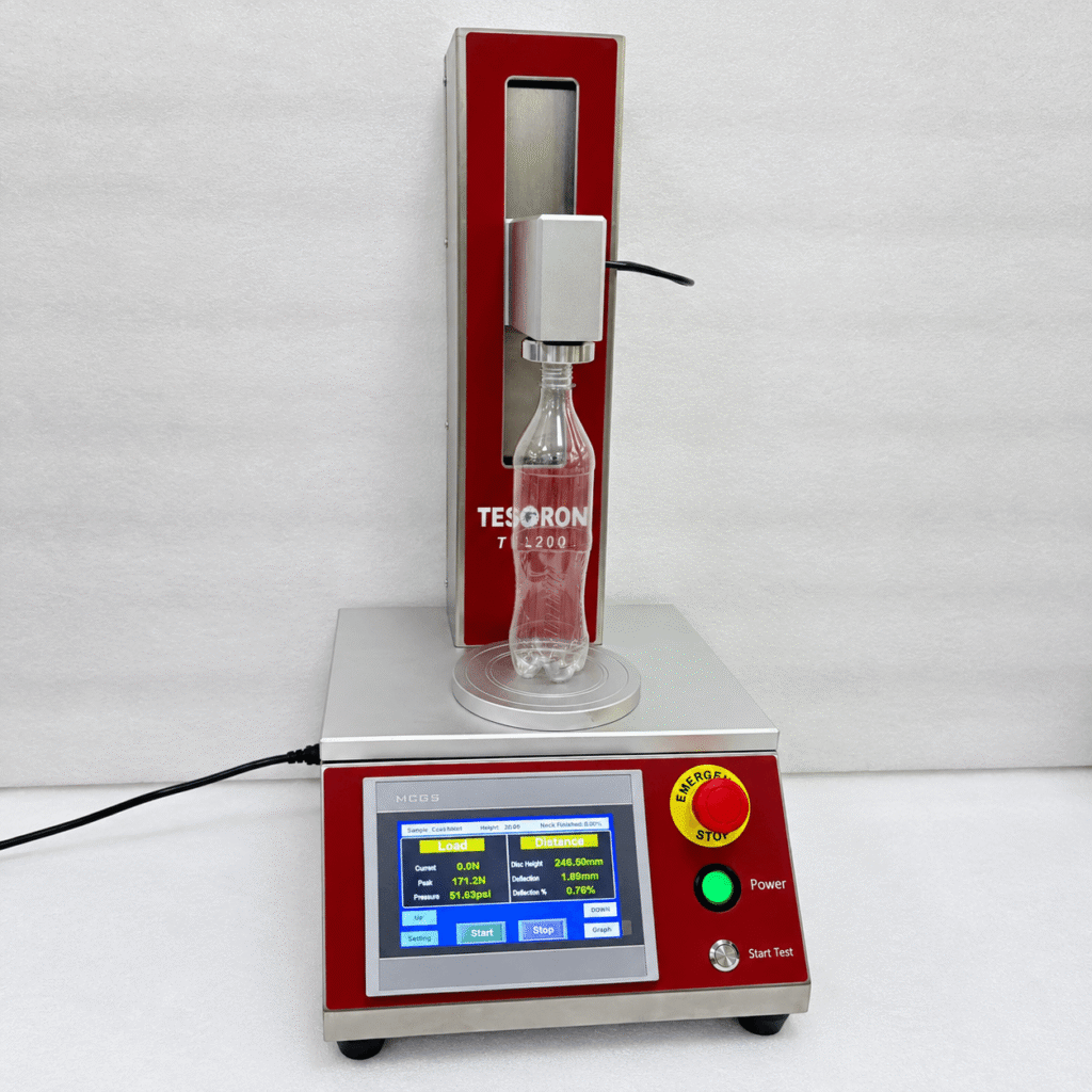 Heavy-duty compression platen and frame on a modern bottle top load testing machine.